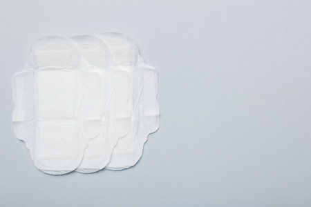 Women hygiene products or sanitary pad on colored background. pastel color. closeup. Empty place for text. Female daily hygiene.の写真素材