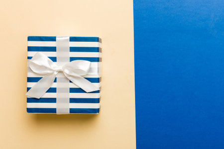 holiday handmade paper present tied white ribbon bow top view with copy space. Flat lay holiday background. birthday or christmas present. Christmas gift box concept with copy space.の写真素材