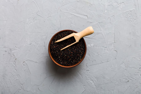 quinoa seeds in bowl and spoon on colored background. Healthy kinwa in small bowl. Healthy superfood.の写真素材