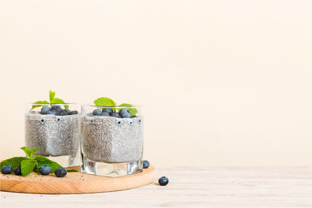 Healthy breakfast or morning with chia seeds vanilla pudding and blueberry berries on table background, vegetarian food, diet and health concept. Chia pudding with coconut milk and blueberry.の写真素材