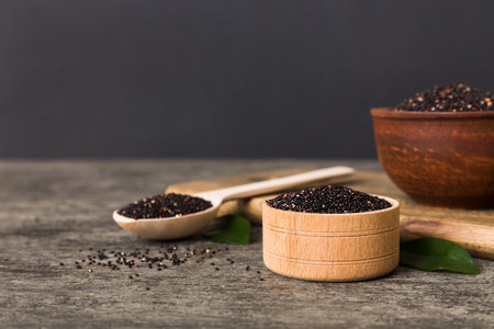 quinoa seeds in bowl and spoon on colored background. Healthy kinwa in small bowl. Healthy superfood.の写真素材