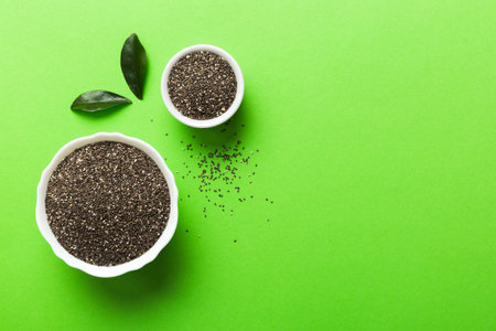 Chia seeds in bowl on colored background. Healthy Salvia hispanica in small bowl. Healthy superfood.の写真素材