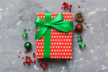 Top view Flat lay Christmas decorations and gift box on colored background with copy space. Christmas or Happy New Year composition.の写真素材