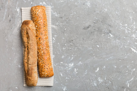 fresh crunchy french baguette on colored table. Top view Bakery products.の写真素材