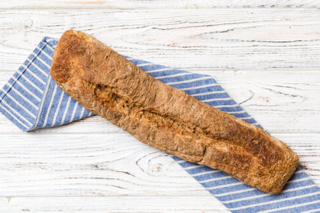 fresh crunchy french baguette on colored table. Top view Bakery products.