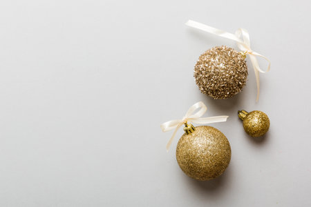 Christmas ball on colored background. decoration bauble with ribbon bow with copy space.の写真素材