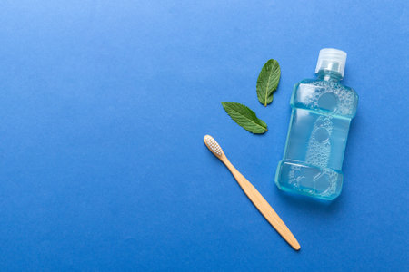 Mouthwash and fresh mint on colored background, top view with copy space for text.の写真素材