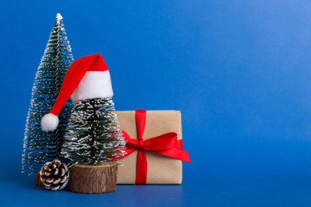 christmas composition. craft Gift box, small tree, branches and craft DIY decorations on white background. new year concept. Christmas home decoration Flat lay, top view, copy space.の写真素材