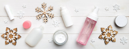 Makeup products and Christmas decorations on color background. Top view New Year Beauty concept with copy space.の写真素材