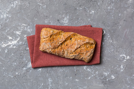 Fresh loaves of bread with wheat and gluten on a colored table. bread on napkin on rustic...