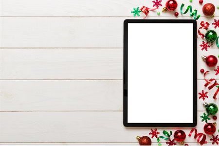Christmas online shopping from home tablet pc with blank white display top view. Tablet with copy...