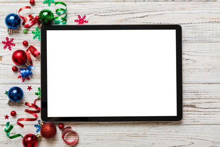 Christmas online shopping from home tablet pc with blank white display top view. Tablet with copy...