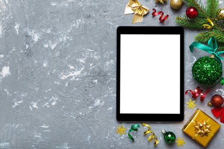 Digital tablet mock up with rustic Christmas decorations for app presentation top view with empty space for you design. Christmas shopping concept. Tablet with copy space on colored background.の写真素材
