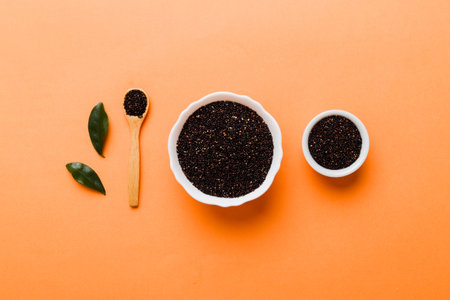 quinoa seeds in bowl and spoon on colored background. Healthy kinwa in small bowl. Healthy superfood.の写真素材