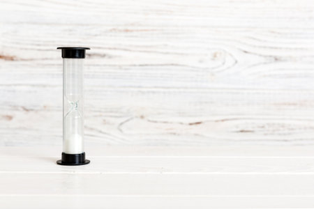 hourglass on the table, sand clock as time passing concept for business deadline, copy space.