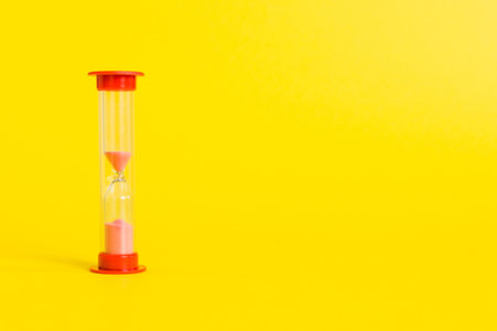 hourglass on the table, sand clock as time passing concept for business deadline, copy space.の写真素材