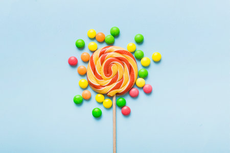 Tasty appetizing Party Accessories Happy Birthday Sweet. Different types of candies on colored background, copy space. Colorful birthday party background.の写真素材