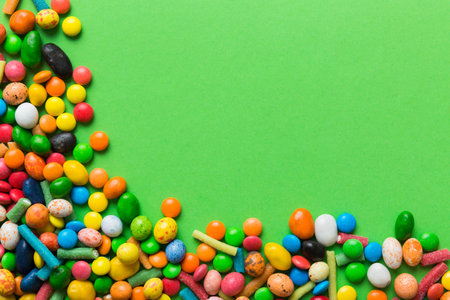 Mixed collection of colorful candy, on colored background. Flat lay, top view. frame of colorful...