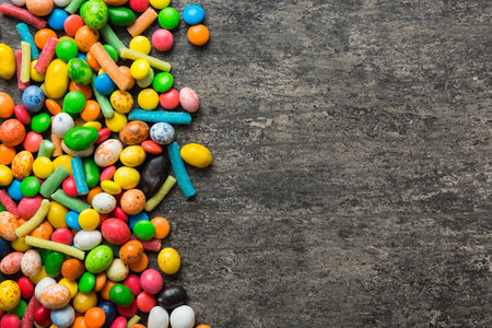 Mixed collection of colorful candy, on colored background. Flat lay, top view. frame of colorful...