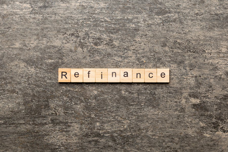 Refinance word written on wood block. Refinance text on cement table for your design, concept.の写真素材