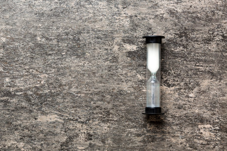 hourglass on the table, sand clock as time passing concept for business deadline, copy space.