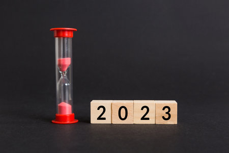 New Year 2023 sand timer. Resolution, time, plan, goal, motivation, reboot, countdown and New Year holiday concepts. Hourglass number 2023.の写真素材