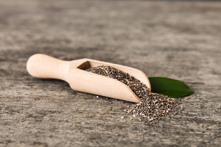 Wooden spoon and chia seeds on colored background, top view. Healthy Salvia hispanica Healthy superfood.の写真素材