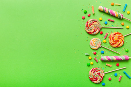 Tasty appetizing Party Accessories Happy Birthday Sweet. Different types of candies on colored background, copy space. Colorful birthday party background.の写真素材