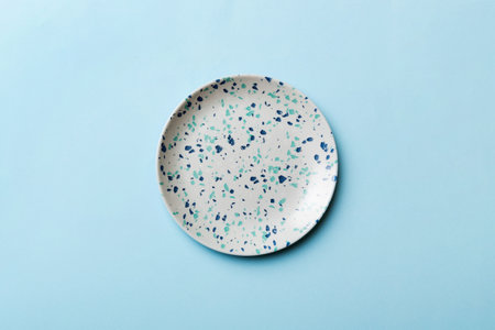 Top view of isolated of colored background empty round blue plate for food. Empty dish with space for your design.の写真素材