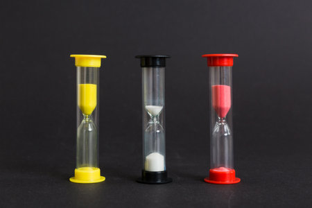 hourglass on the table, sand clock as time passing concept for business deadline, copy space.の写真素材