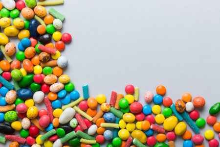 Mixed collection of colorful candy, on colored background. Flat lay, top view. frame of colorful...