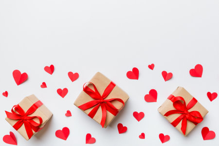 Valentine day composition: red gift box with bow and heart. Christmas present. View from above. Space for text. Holday greeting card.の写真素材