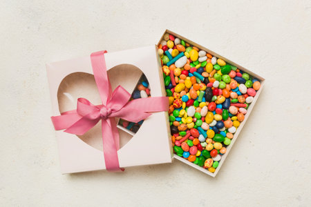 Box with sweet chocolate candies on color background, Various candy sweets. Valentine's day gift...