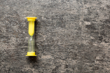 hourglass on the table, sand clock as time passing concept for business deadline, copy space.の写真素材