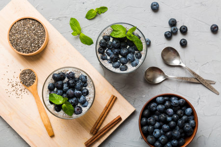 Healthy breakfast or morning with chia seeds vanilla pudding and blueberry berries on table background, vegetarian food, diet and health concept. Chia pudding with coconut milk and blueberry.の写真素材