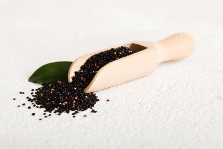 quinoa seeds in spoon on colored background. Healthy kinwa in small spoon. Healthy superfood.の写真素材