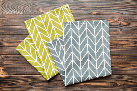 top view with blue kitchen napkin isolated on table background. Folded cloth for mockup with copy...