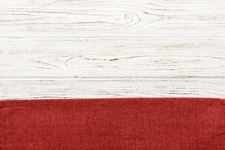 top view with red empty kitchen napkin isolated on table background. Folded cloth for mockup with copy space, Flat lay. minimal style.の写真素材