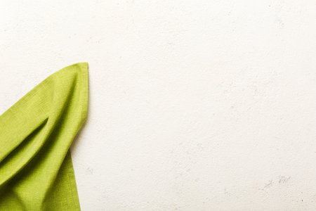 top view with green kitchen napkin isolated on table background. Folded cloth for mockup with copy space, Flat lay. minimal style.の写真素材