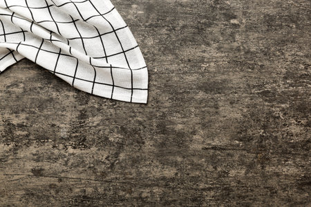 top view with white empty kitchen napkin isolated on table background. Folded cloth for mockup with copy space, Flat lay. minimal style.の写真素材