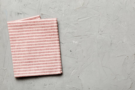 top view with red empty kitchen napkin isolated on table background. Folded cloth for mockup with copy space, Flat lay. minimal style.の写真素材