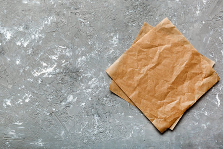 top view with baking parchment empty on table background. Folded cloth for mockup with copy space, Flat lay. minimal style.の写真素材