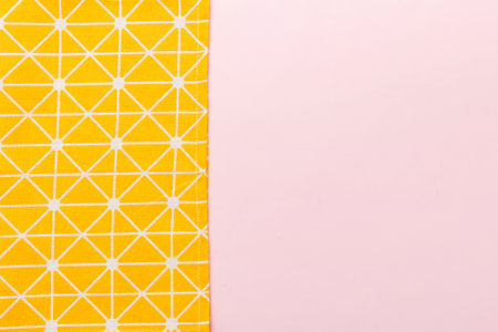 top view with yellow empty kitchen napkin isolated on table background. Folded cloth for mockup with copy space, Flat lay. minimal style.の写真素材