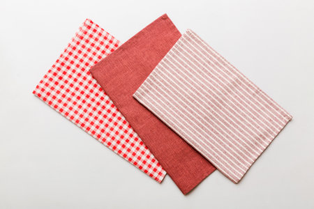 top view with red empty kitchen napkin isolated on table background. Folded cloth for mockup with...