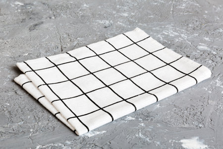 top view with white empty kitchen napkin isolated on table background. Folded cloth for mockup with copy space, Flat lay. minimal style.の写真素材