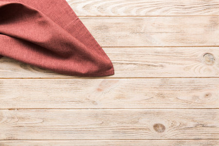 top view with red empty kitchen napkin isolated on table background. Folded cloth for mockup with copy space, Flat lay. minimal style.の写真素材