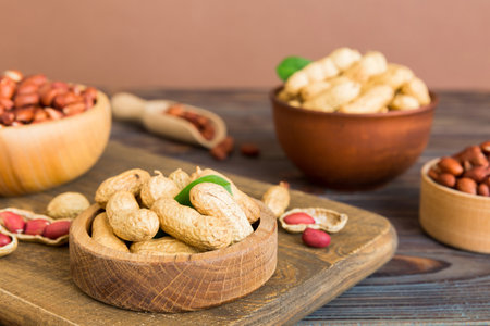 Fresh healthy peanuts in bowl on colored table background. Top view Healthy eating bertholletia concept. super foods.の写真素材