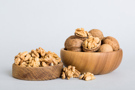 Fresh healthy walnuts in bowl on colored table background. Top view Healthy eating bertholletia...