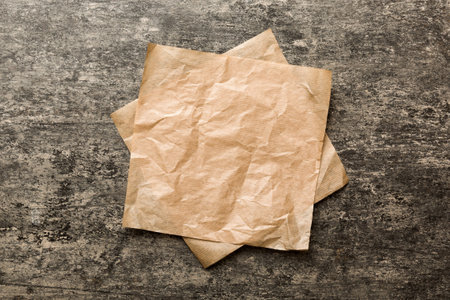 top view with baking parchment empty on table background. Folded cloth for mockup with copy space, Flat lay. minimal style.の写真素材