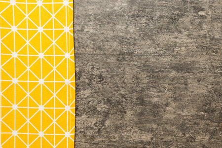 top view with yellow empty kitchen napkin isolated on table background. Folded cloth for mockup with copy space, Flat lay. minimal style.の写真素材